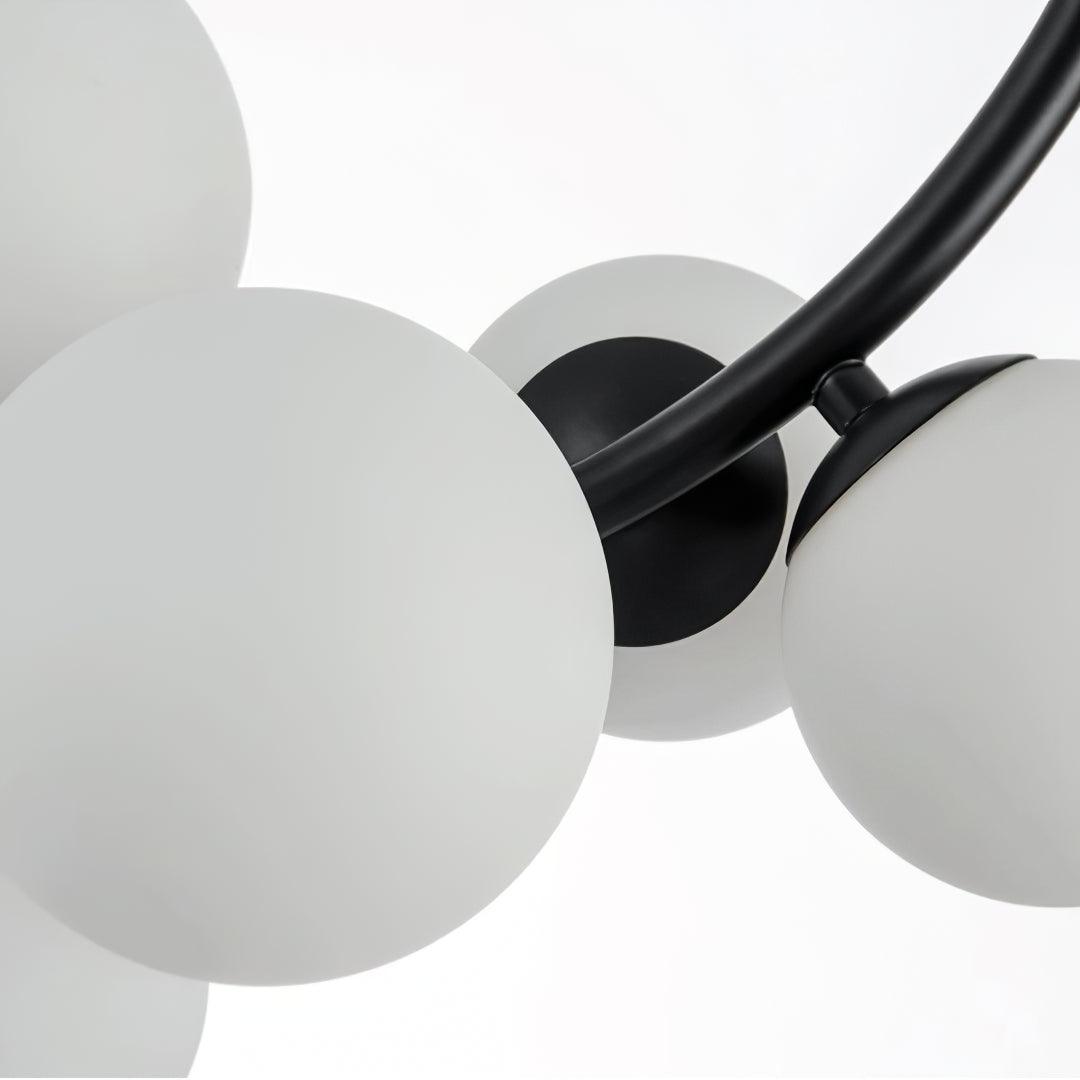 Close-up of white globe shades and Black frame holders