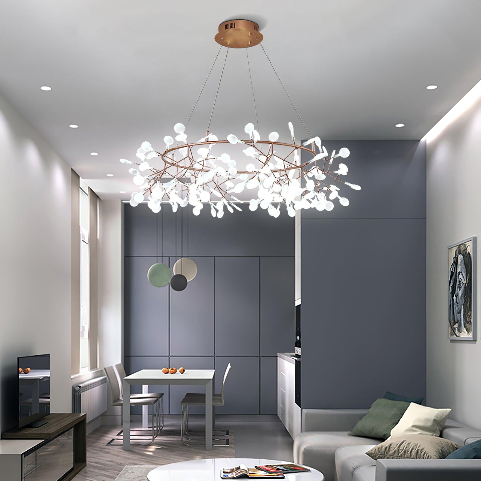Bright white leaf ring chandelier above a pale sofa in an open living and dining room with grey wall panels