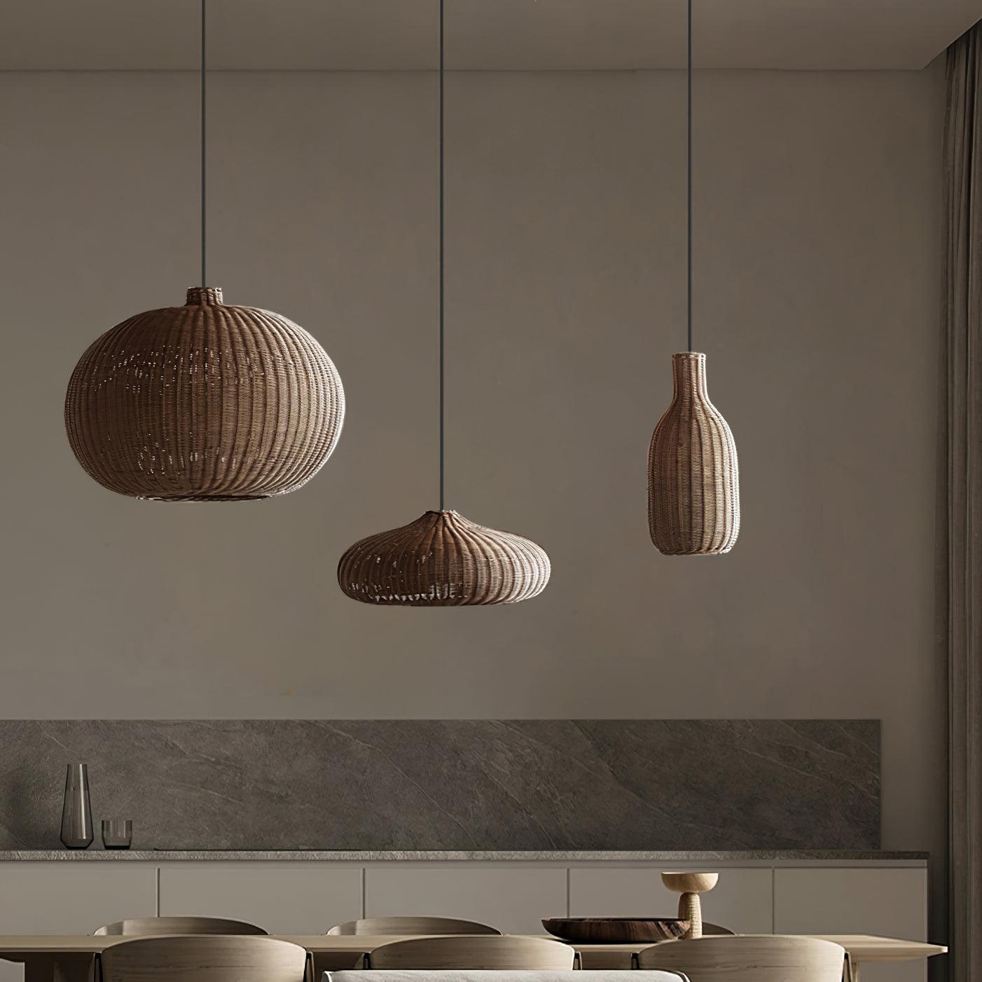 Three rattan pendant shapes over a dining setting