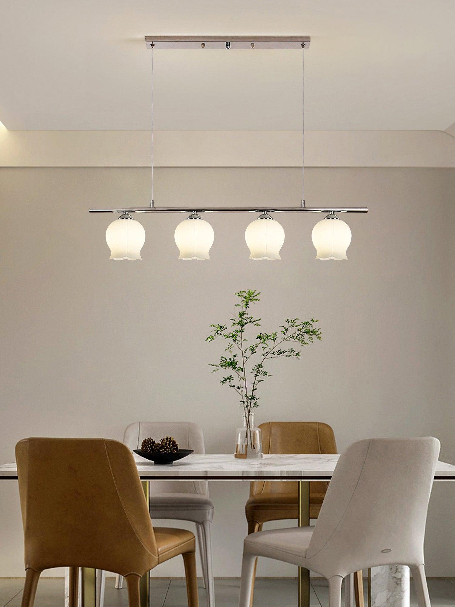 Floral Glass four-head pendant above a table and four chairs