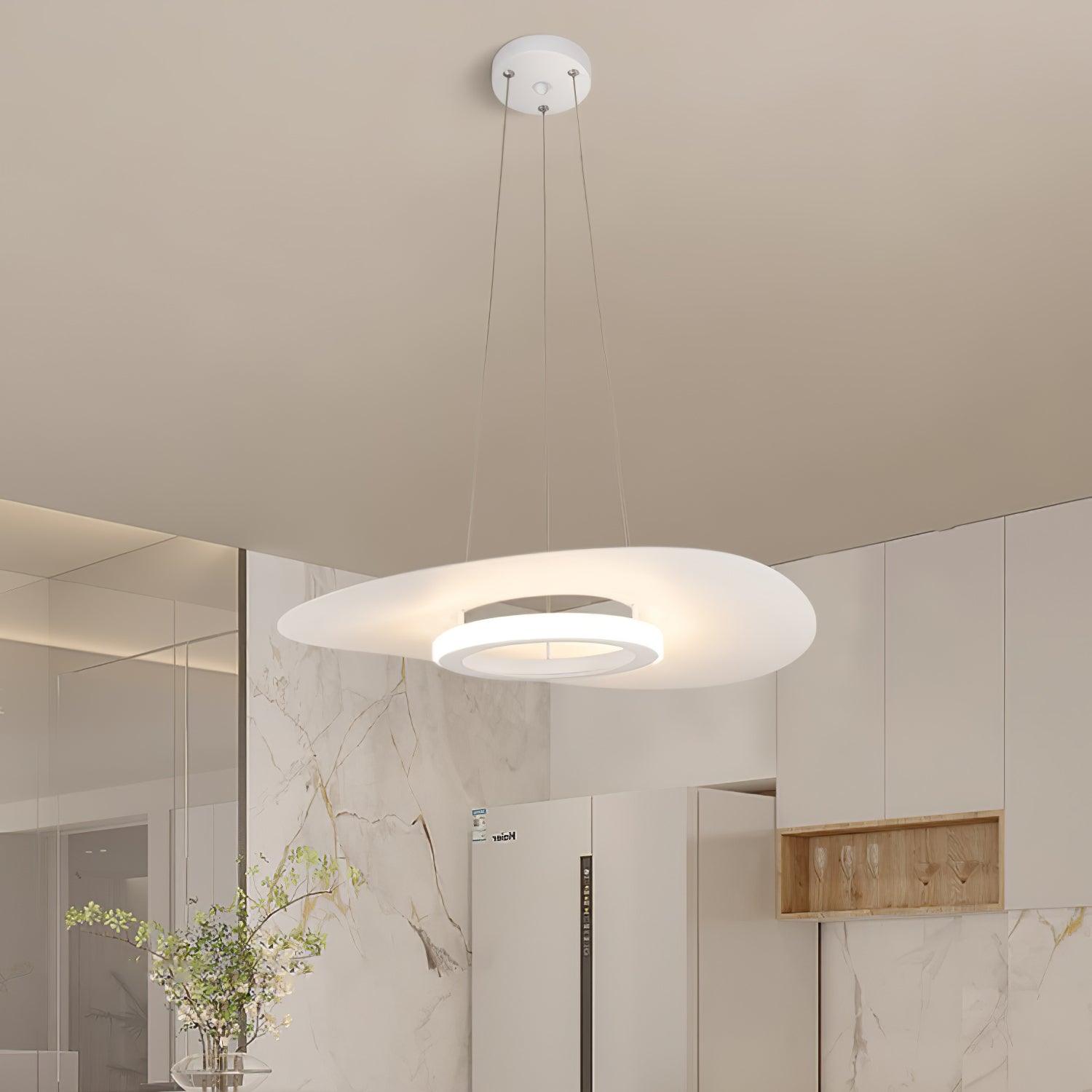 White curved disc pendant with luminous lower ring and round canopy in pale marble kitchen