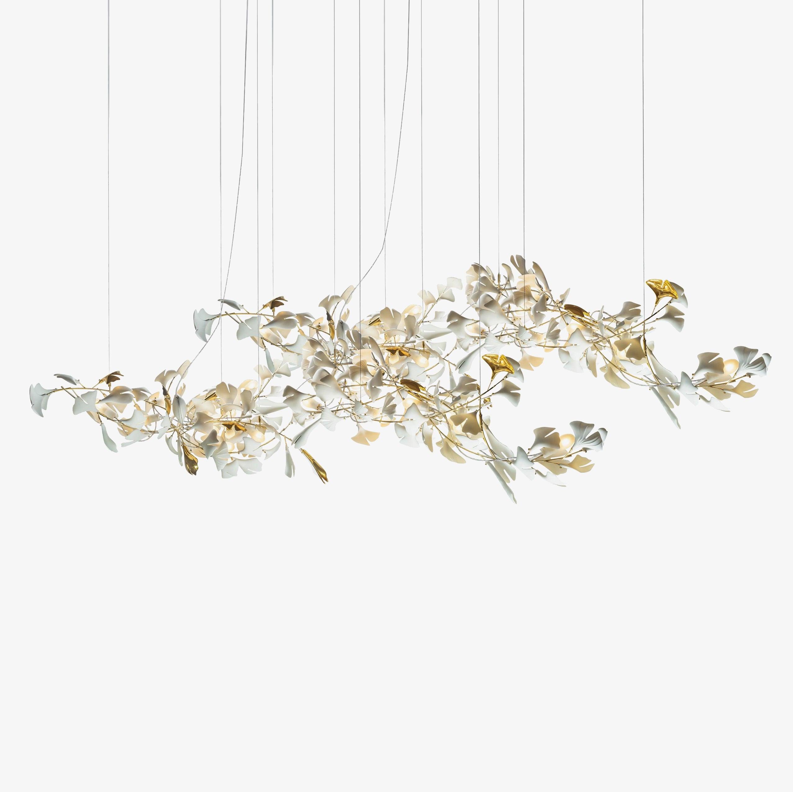 Isolated long ginkgo chandelier with white fan-shaped leaves, gold accents and cropped hanging wires on white