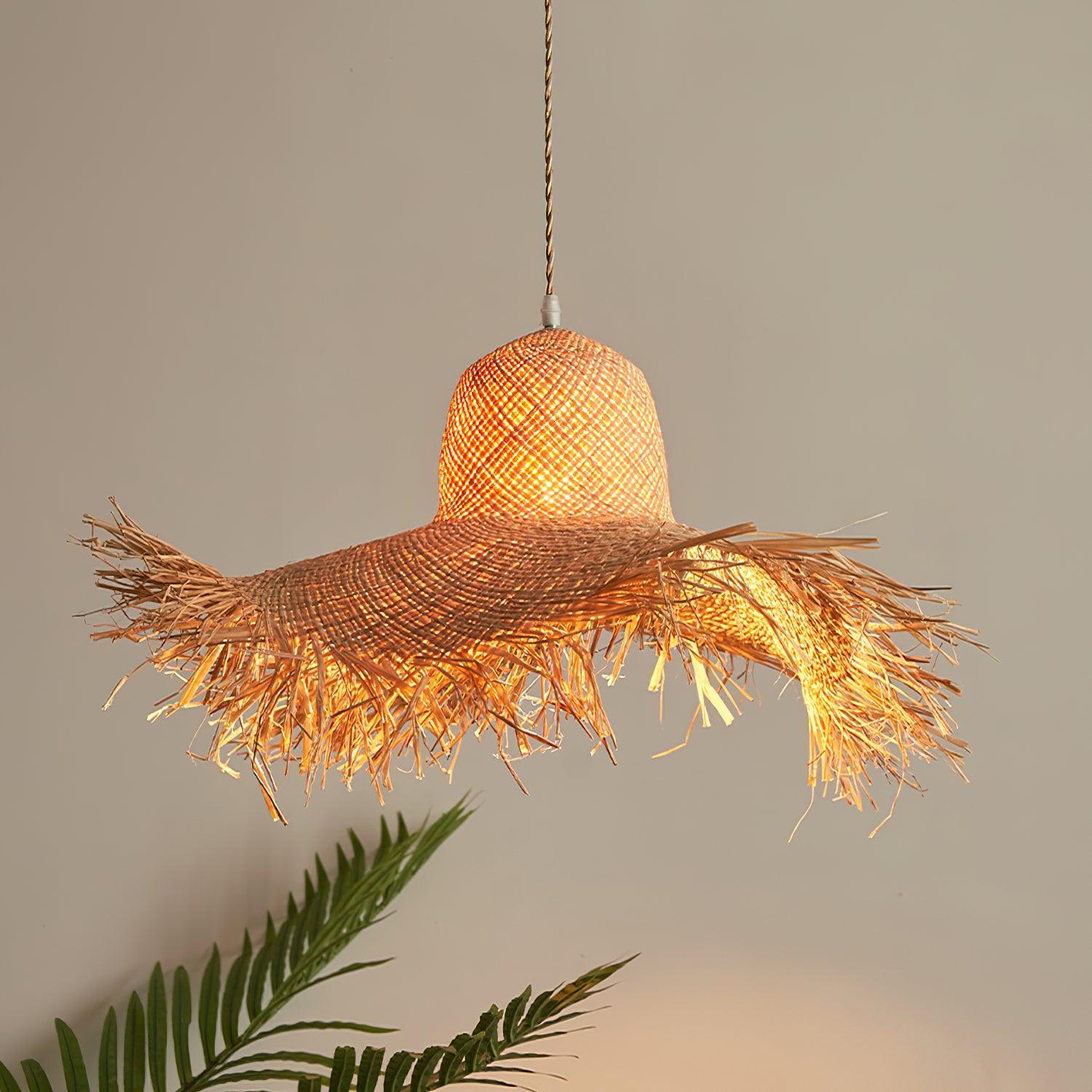 Close warm-lit view of the woven rounded crown and undulating fringed brim beside green palm fronds