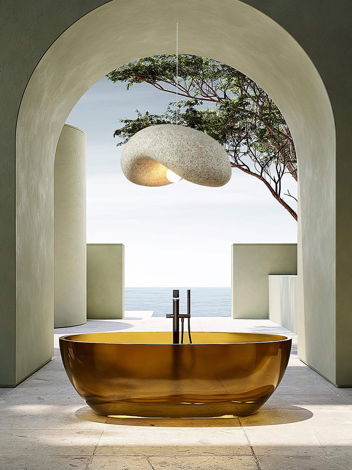 Speckled pendant shown beside a bathtub