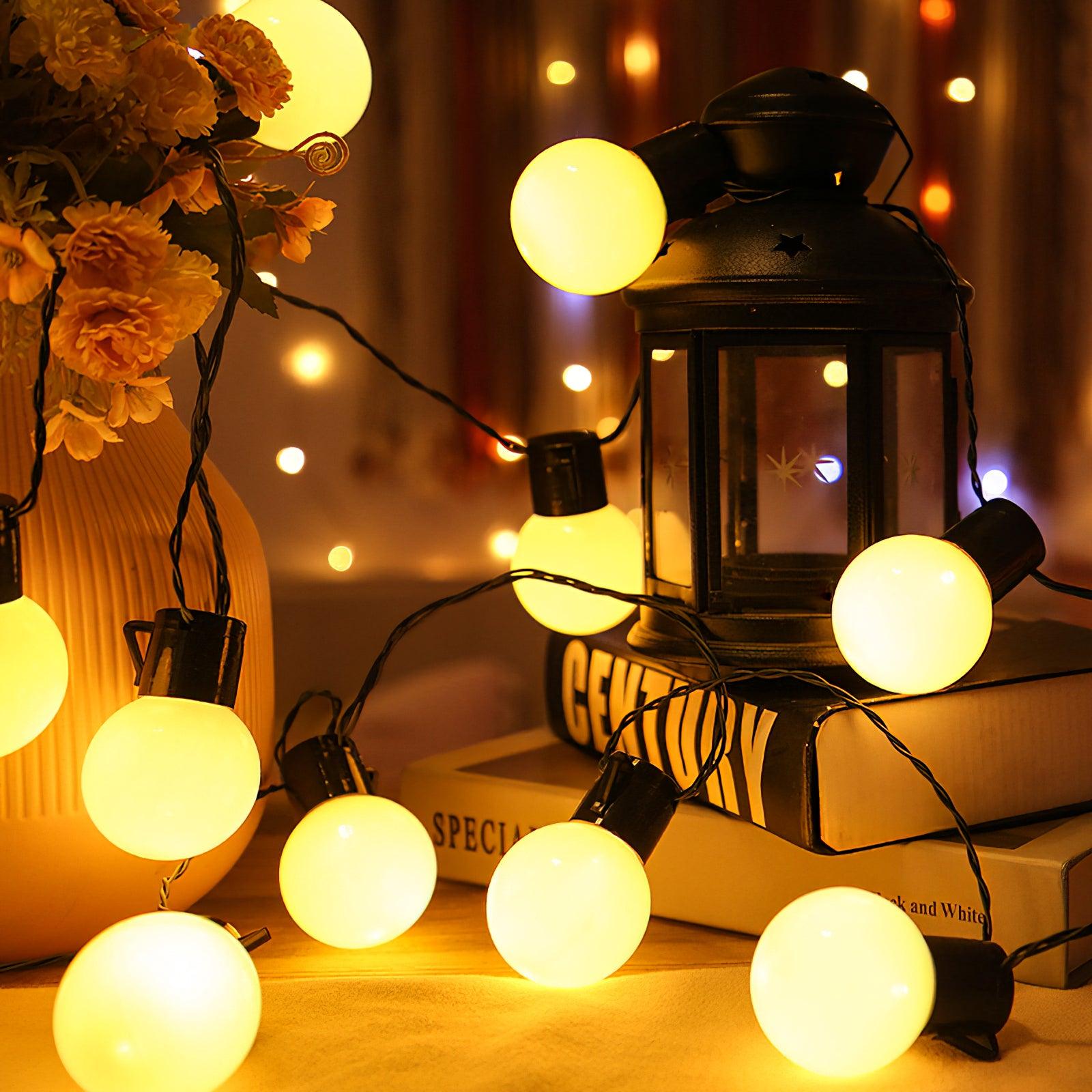 Globe lights photographed beside a lantern