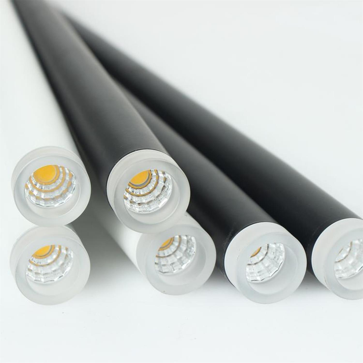 Close-up of black tube ends with white rims and clear faceted light openings
