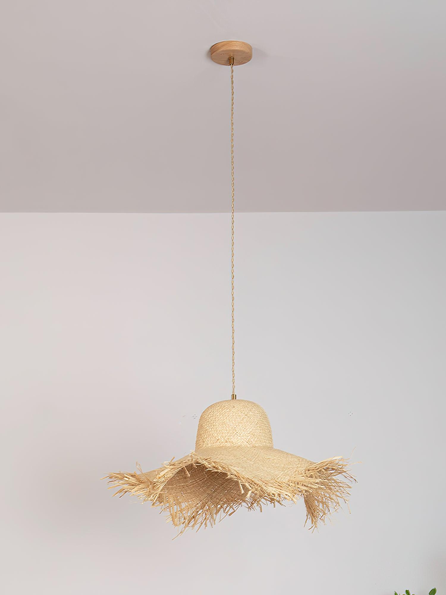 Full unlit fringed hat pendant against a pale wall, with long twisted tan cord and round natural-toned canopy