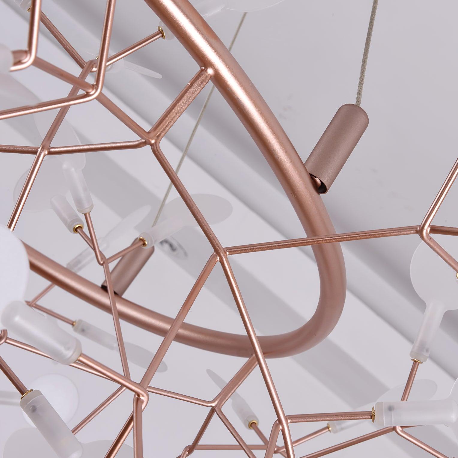 Unlit underside detail of a rose-copper leaf ring chandelier with cylindrical suspension attachment