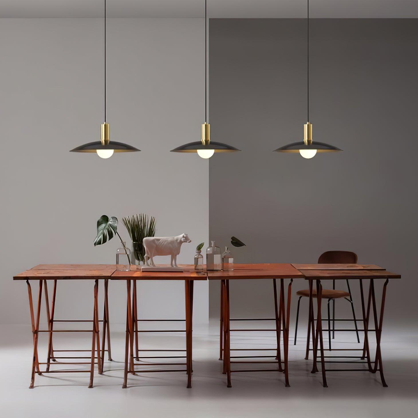 Black flared pendants arranged above a dining table