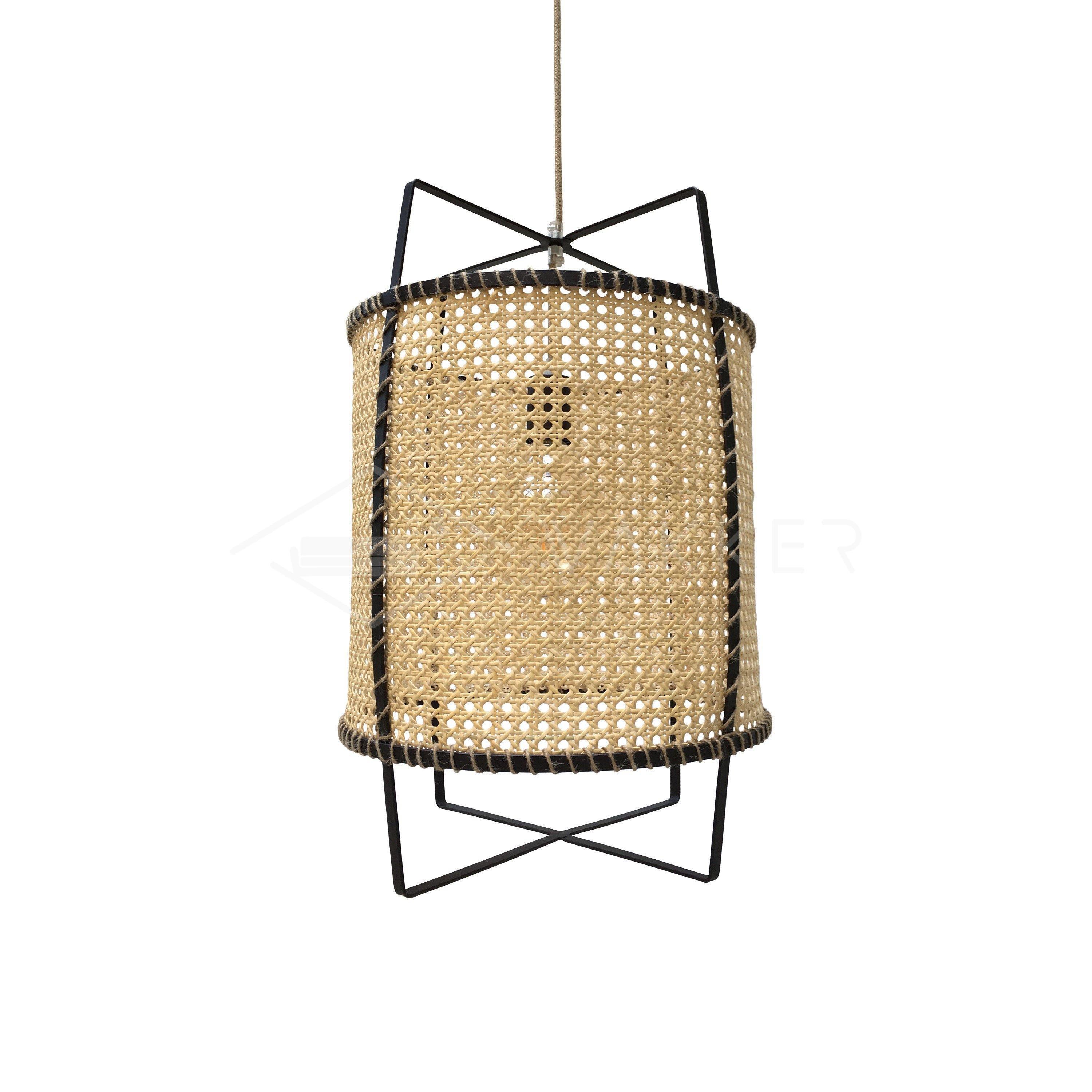 Isolated unlit natural cane pendant with tan hanging cord and crossed black metal extensions