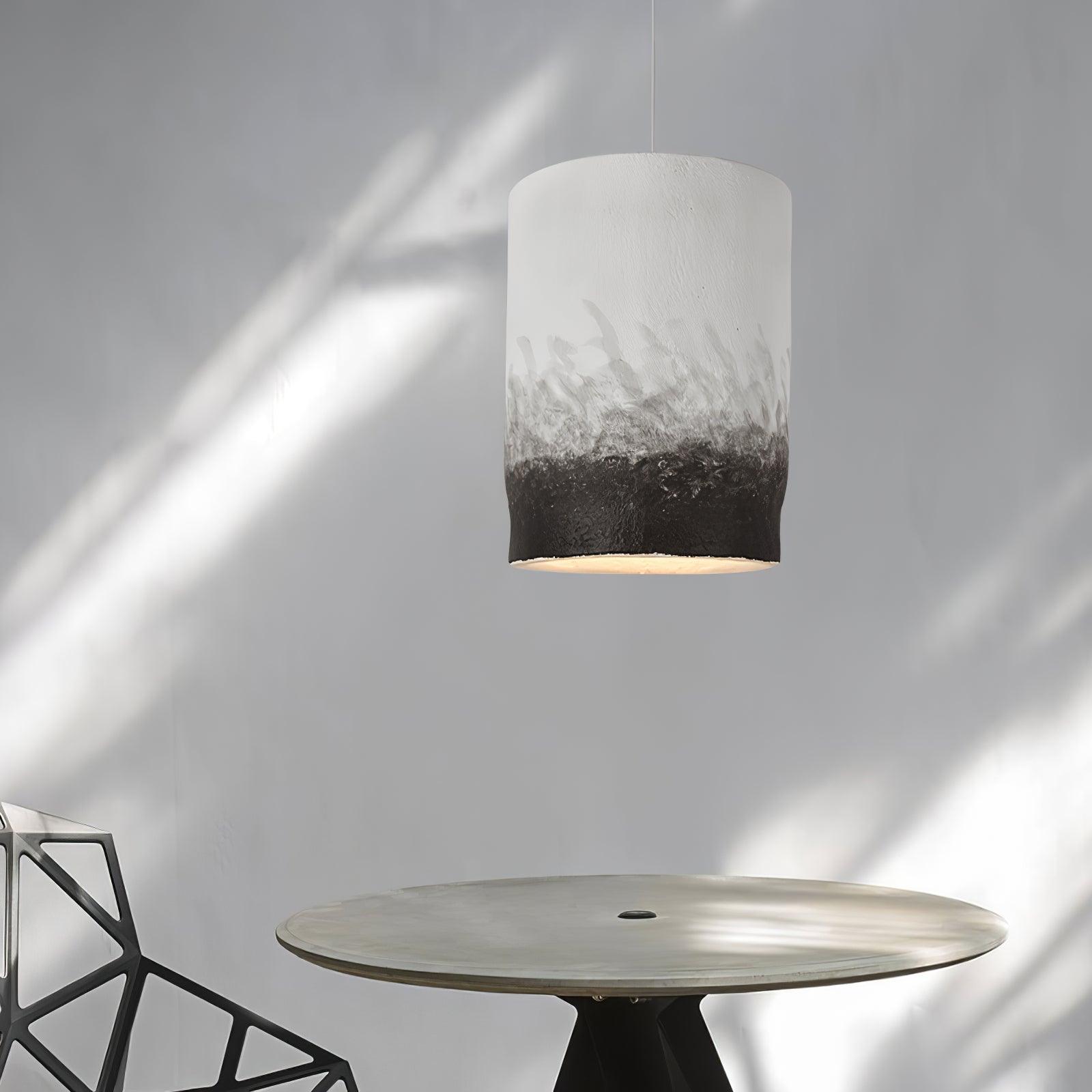 Illuminated textured pendant above a round table