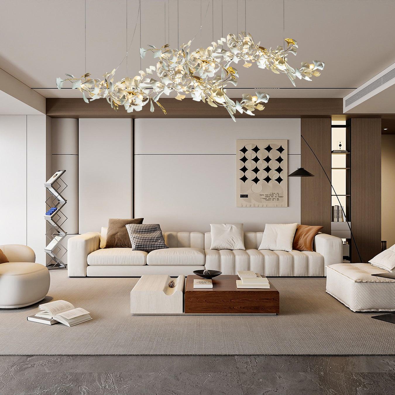 Gold-and-white ginkgo chandelier above a cream sofa and timber coffee table in a pale timber-panel lounge