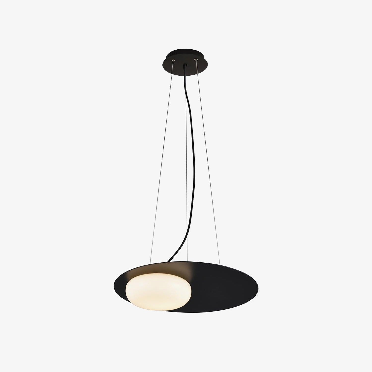 Full black pendant on white, with round canopy, fine support cables, curved cord, thin disc and offset glowing white diffuser.