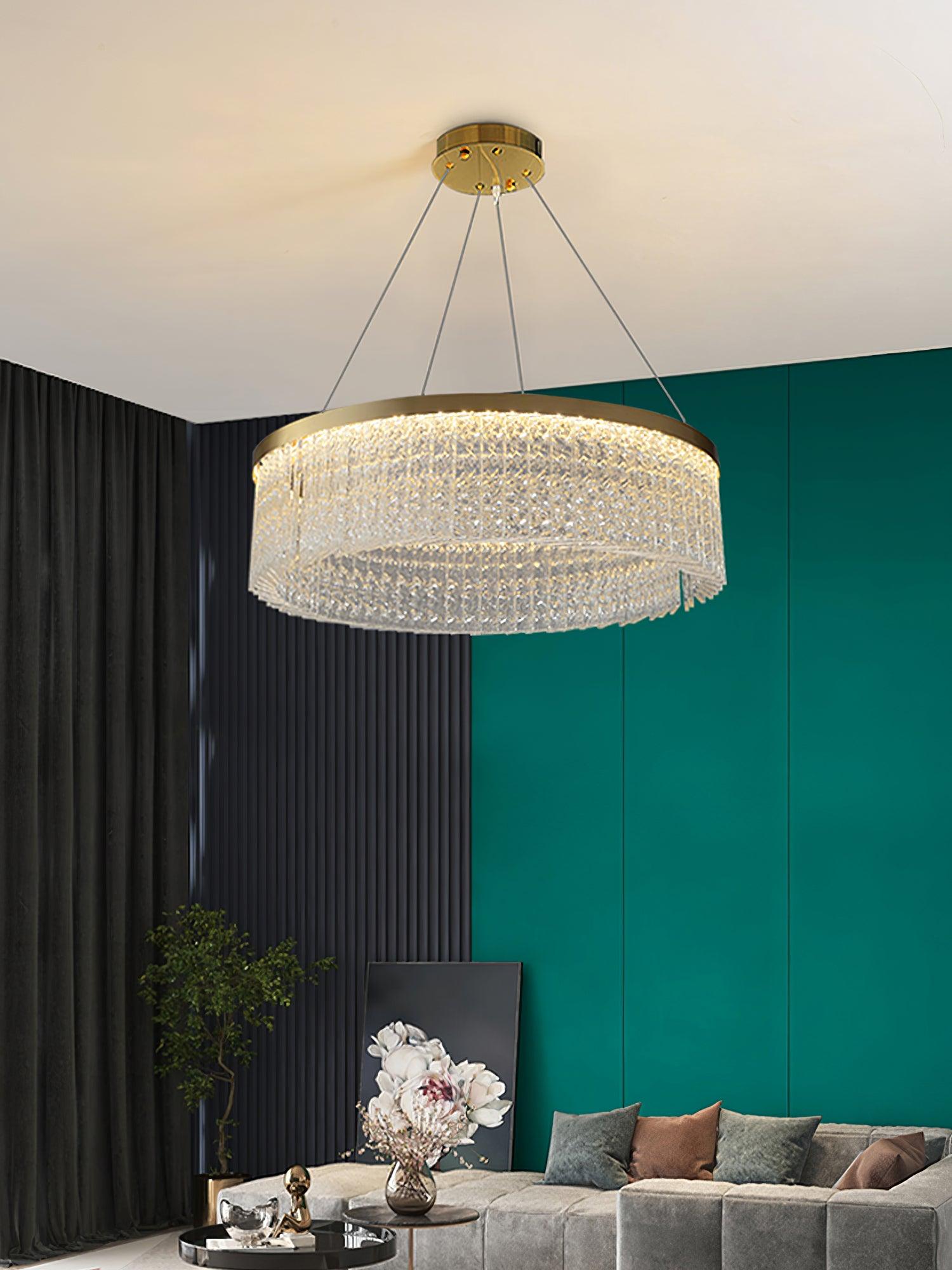 Full crystal ring and round canopy above grey sofa against teal and dark ribbed walls, with floral artwork and round tables