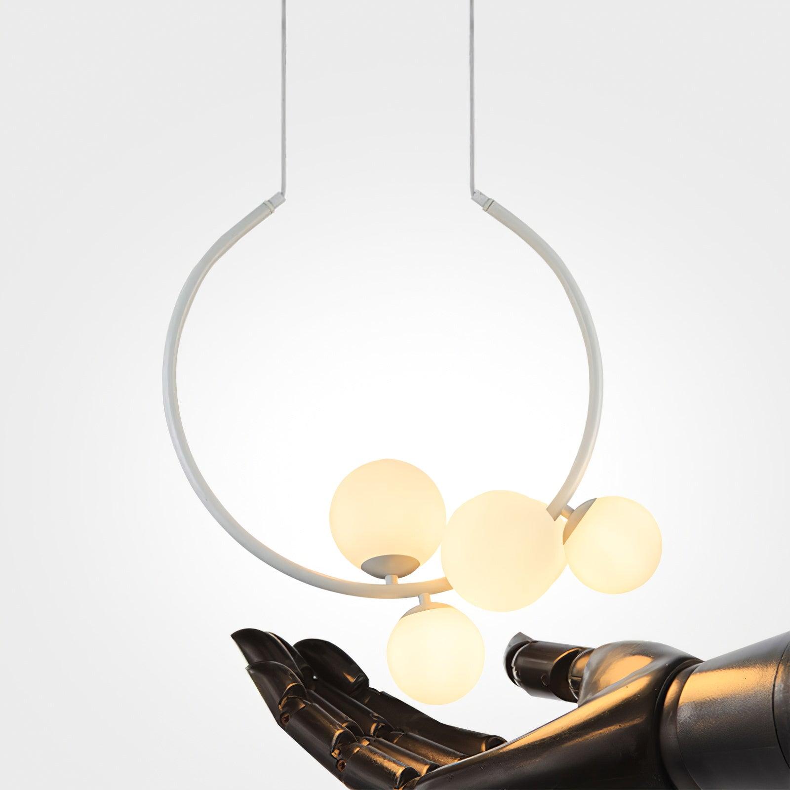 Lit White globe pendant above a sculptural hand prop