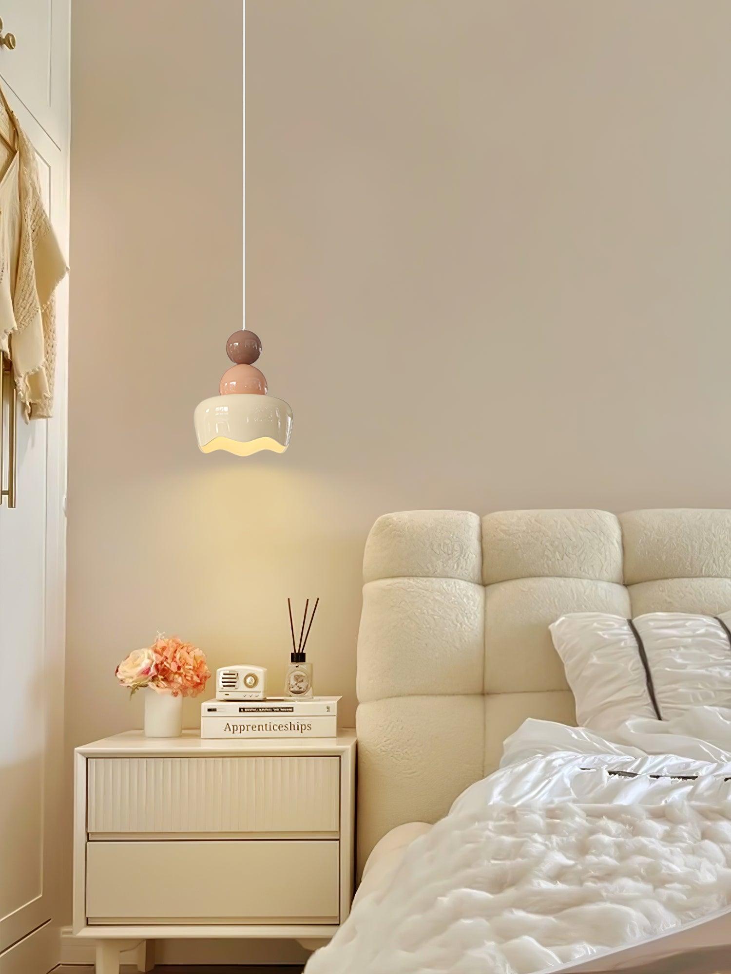 Pink-and-cream pendant in a bedside setting