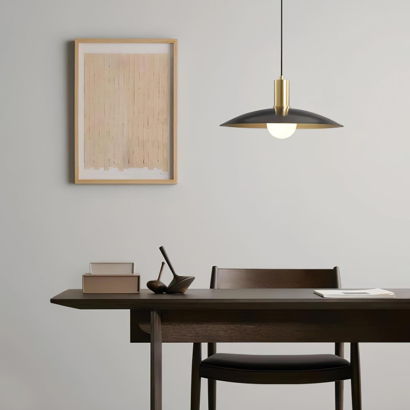 Black and Brass flared pendant in a dining area