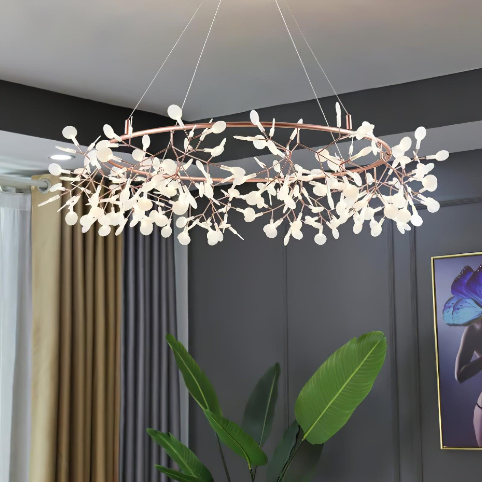 Rose-copper leaf ring chandelier beside tall tropical leaves and blue butterfly artwork against dark panels