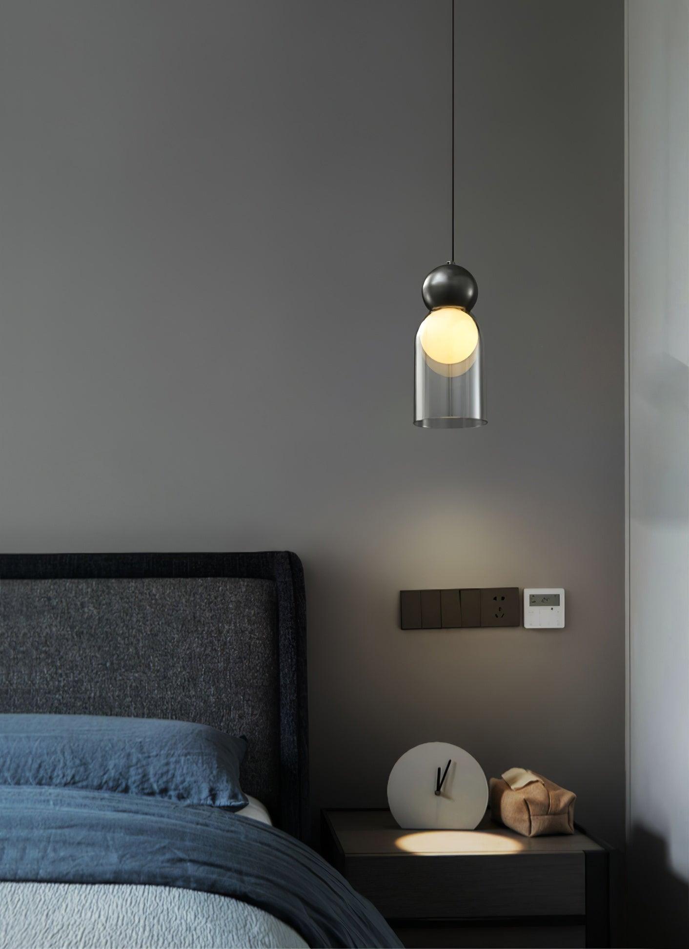 Black Dani pendant beside a bed