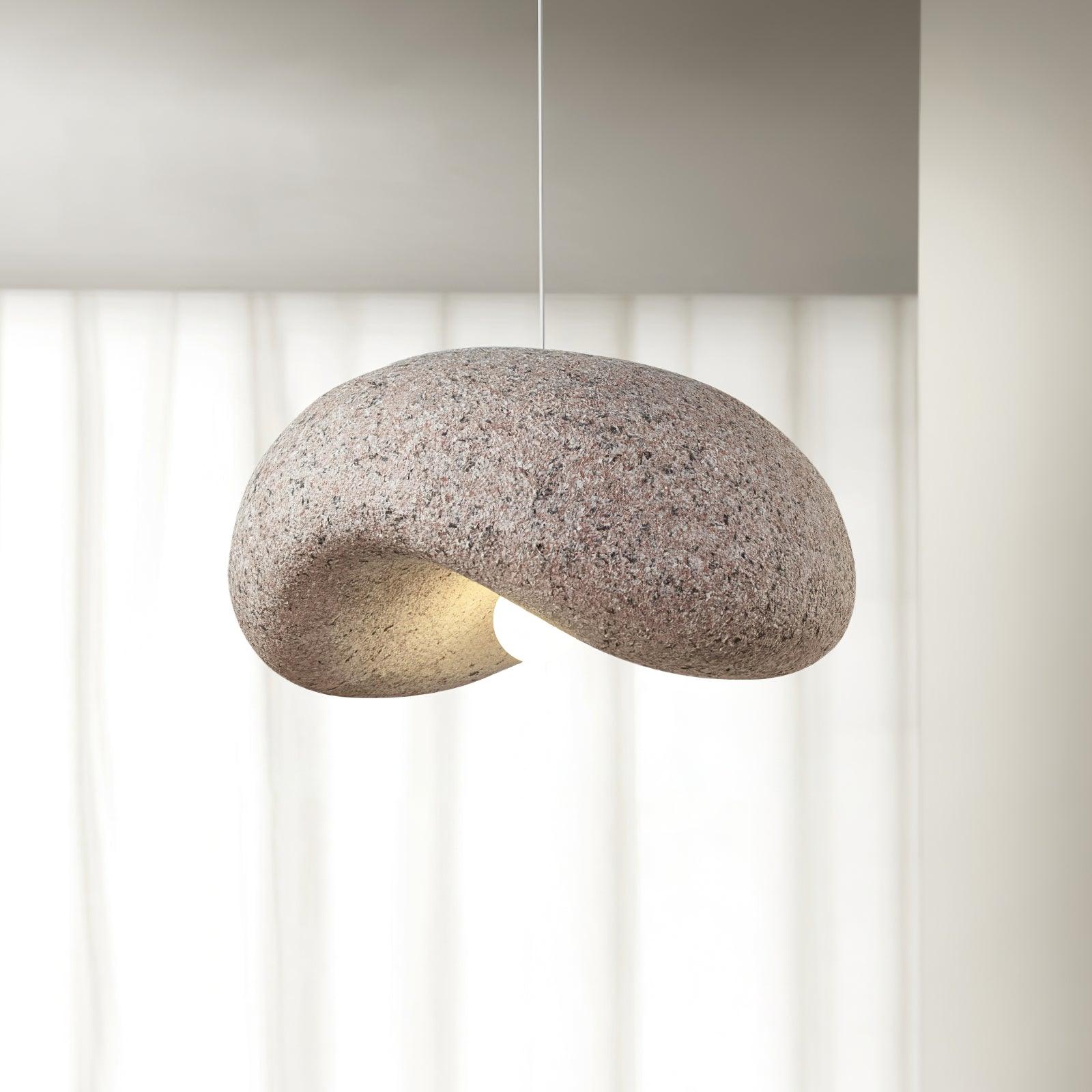 Pink organic pendant beside a window