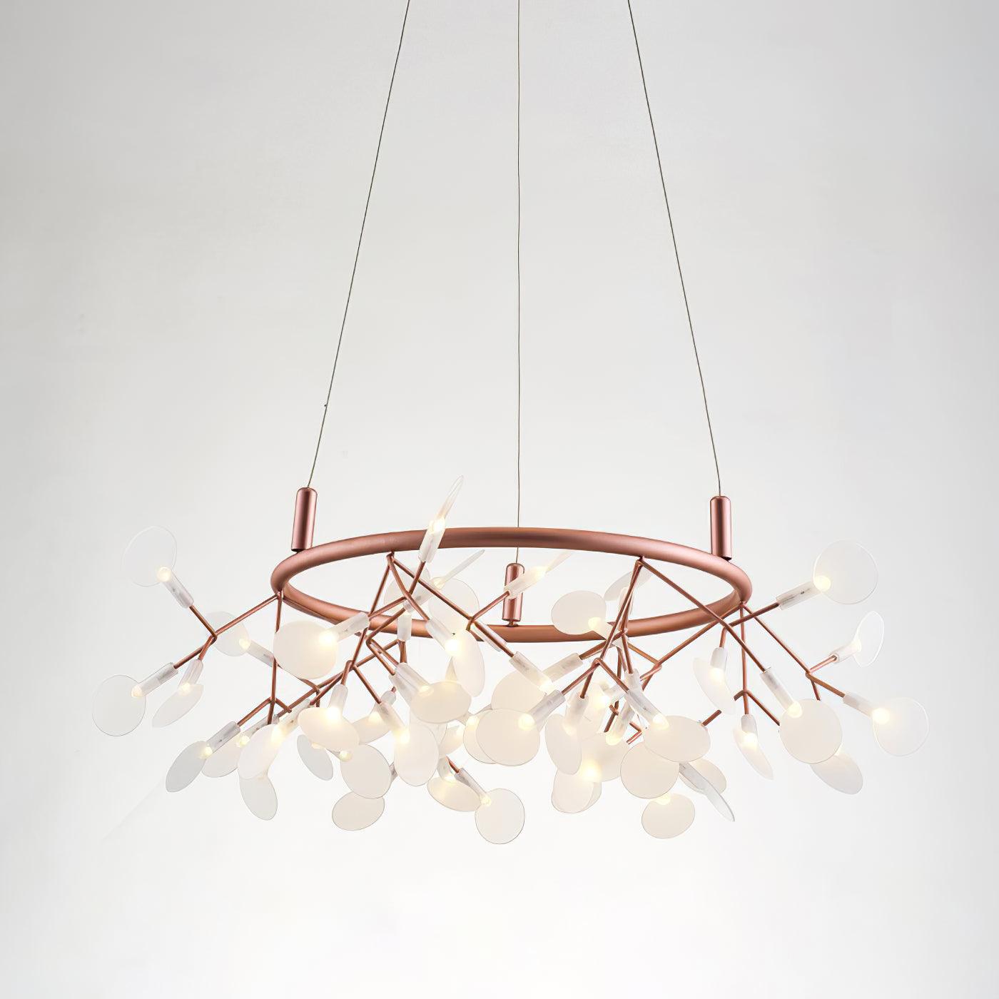 54-head Big O Firefly chandelier close-up with white oval leaves on lit rose-copper branching stems