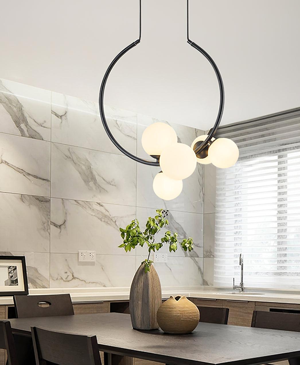 Circular pendant in a marble-patterned kitchen interior