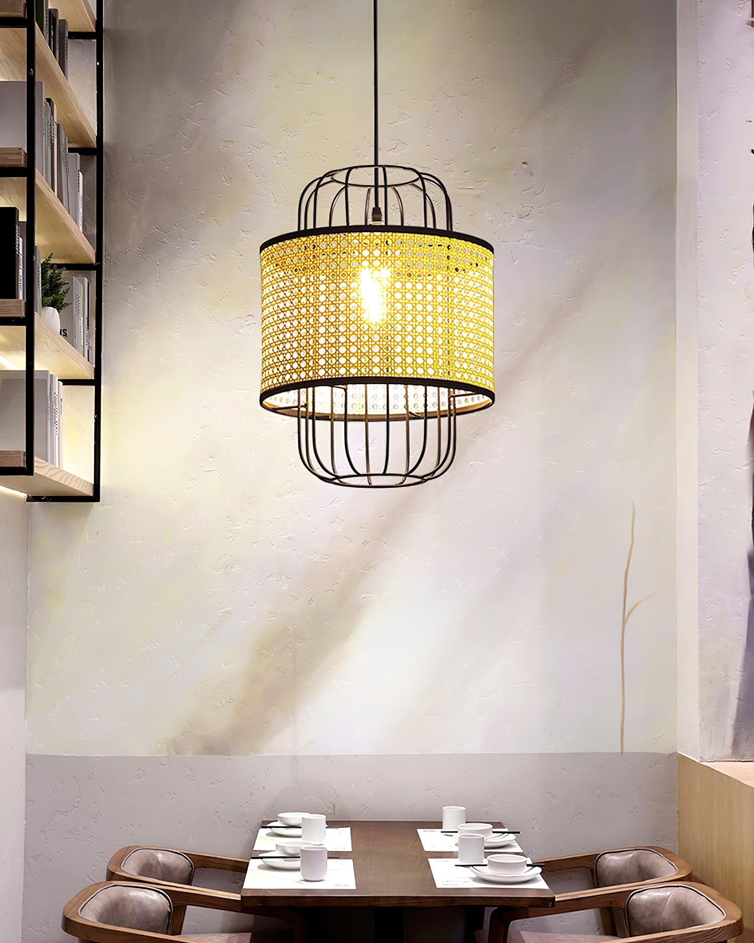Woven rattan and black cage pendant viewed above a dining table