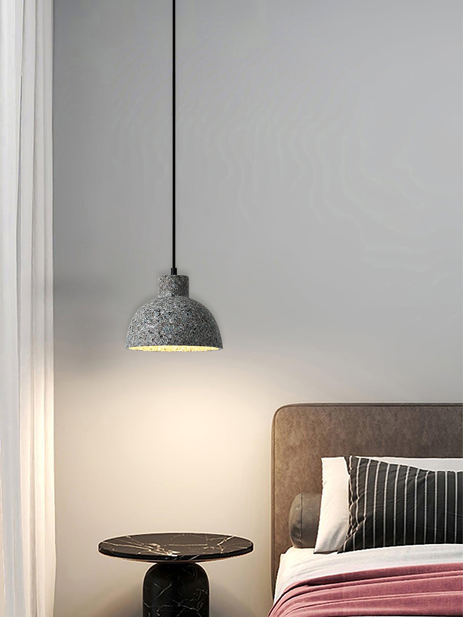 Broad cement bell pendant beside a bed