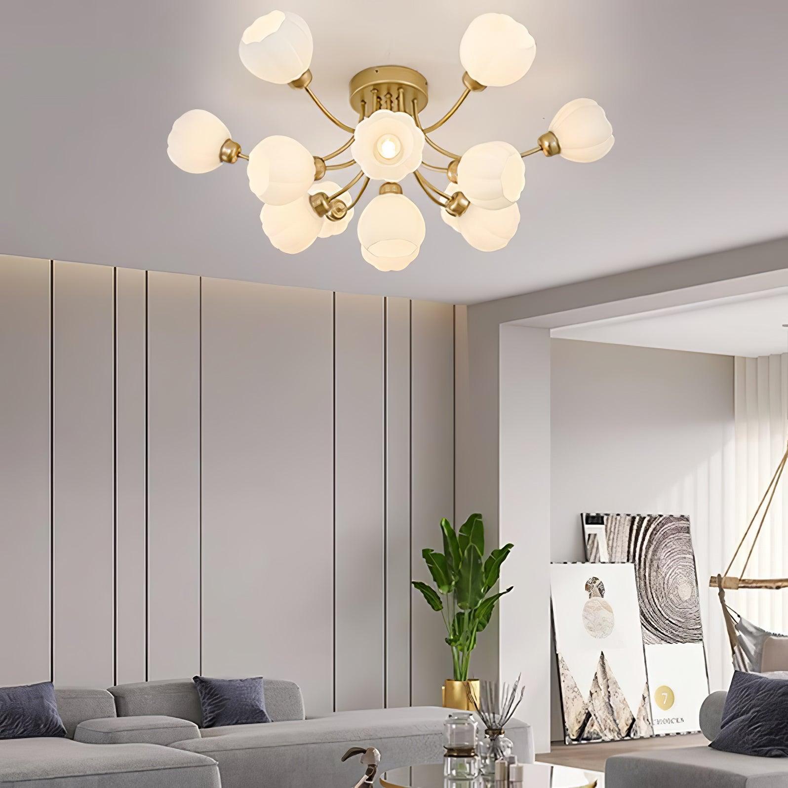 Pumpkin white glass ceiling light with brass-colour arms above a grey sofa and dark wall panels