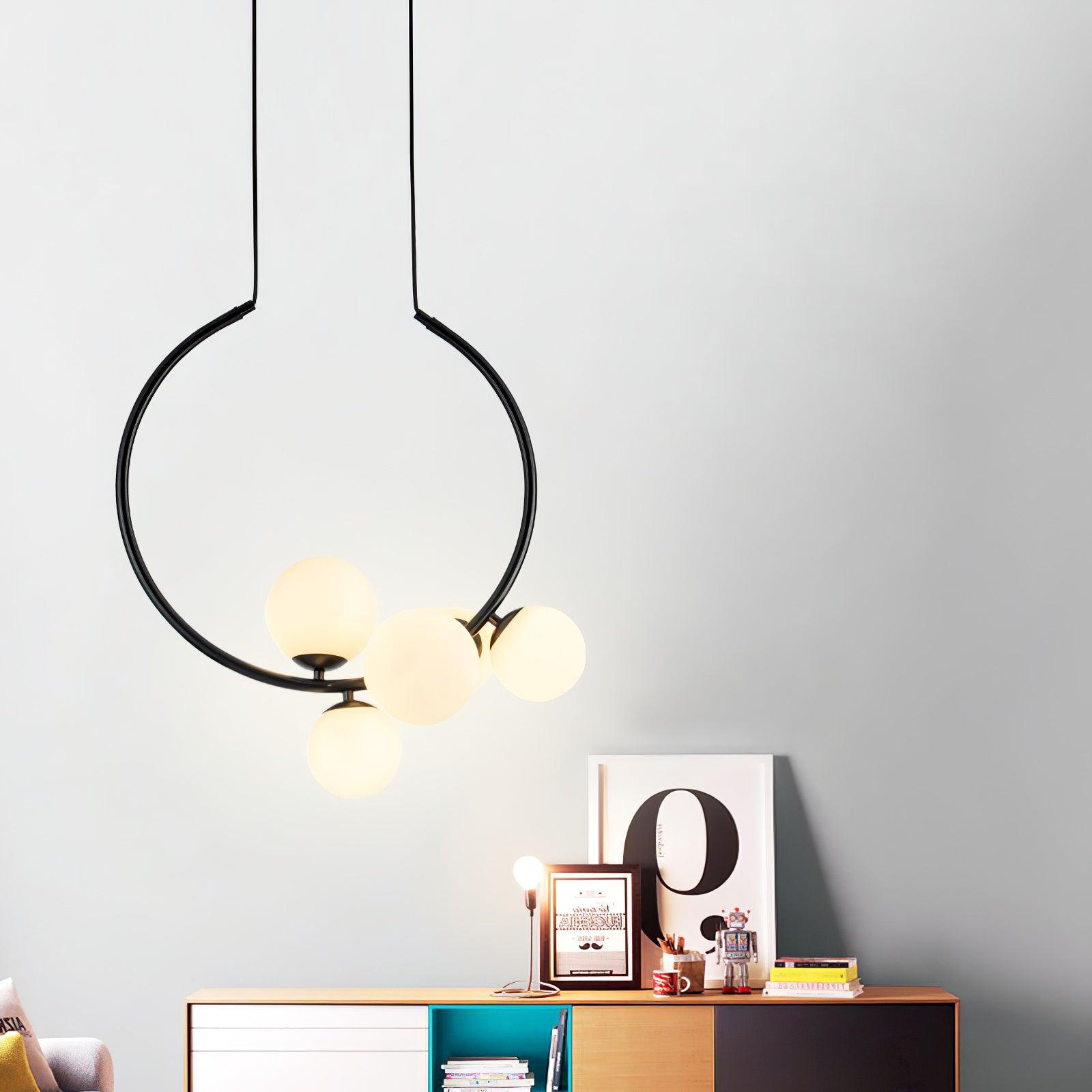 Black circular pendant with warm-lit lower globes