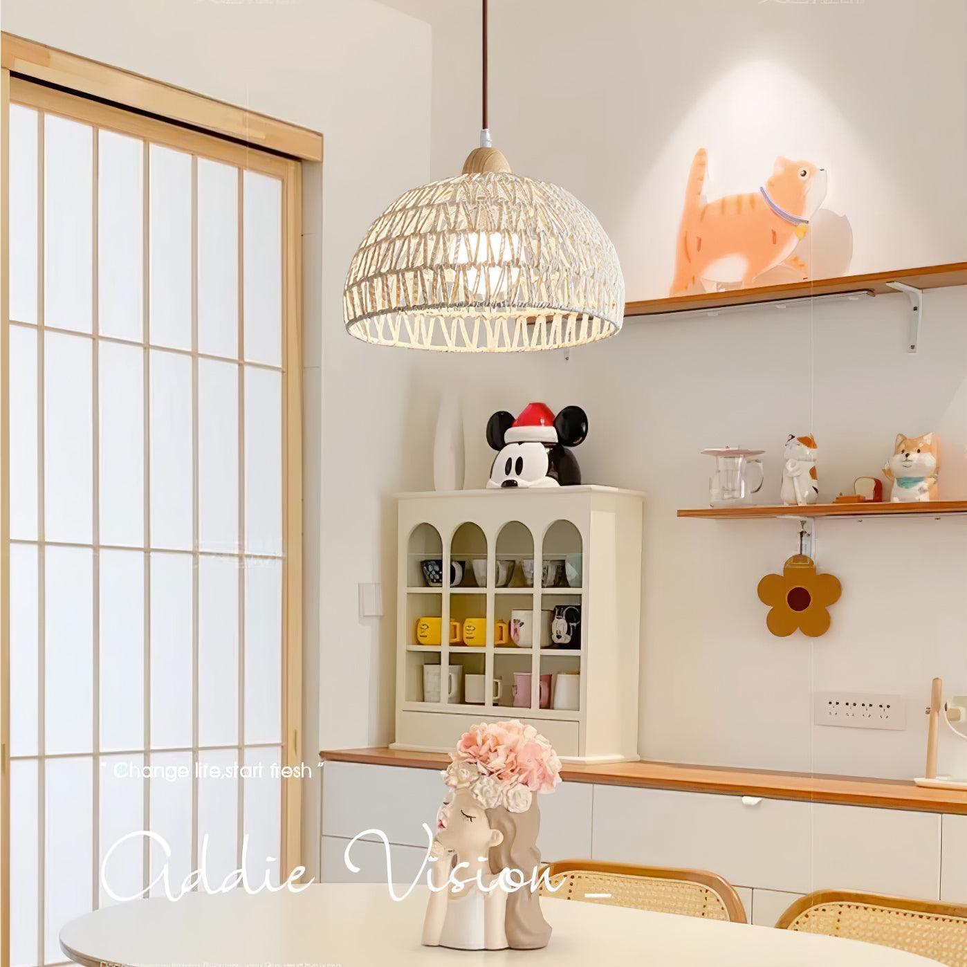Single woven dome pendant above a light dining table with a flower vase beside a glass-paneled door
