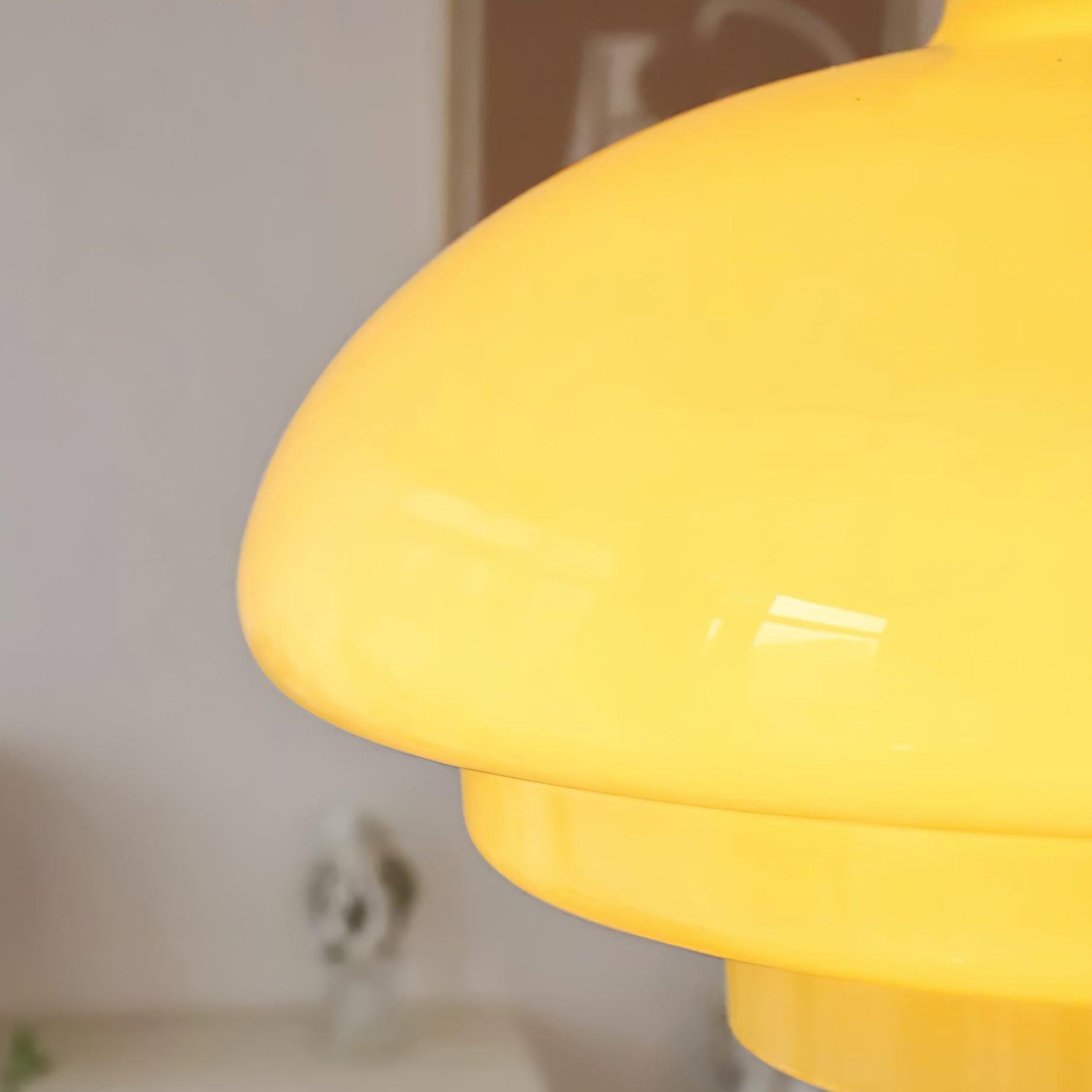 Close detail of yellow glass curvature, glossy reflections and the stepped lower edge
