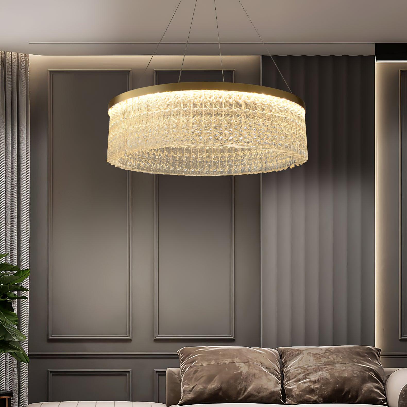 Lit clear-panel ring above brown cushions against dark panelled wall, with curtain and plant at left