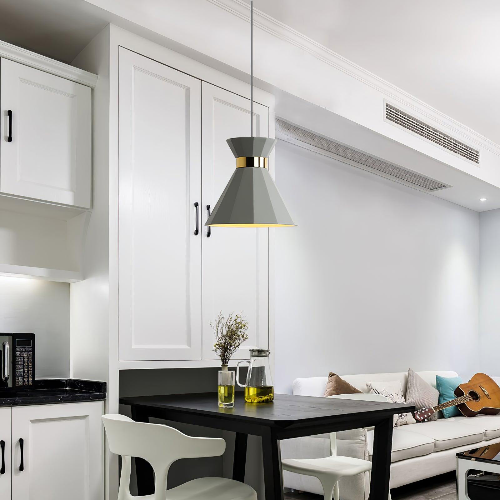 Grey faceted pendant above a dining table