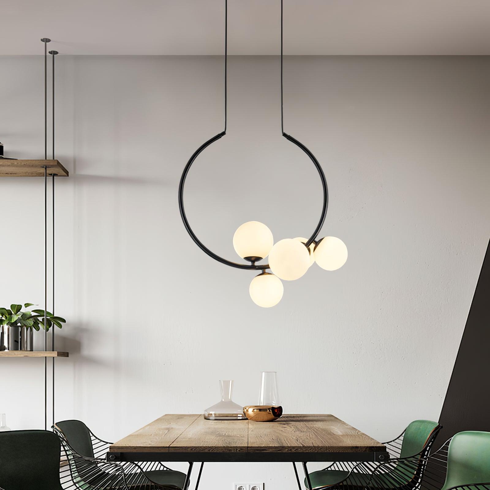 Black globe pendant over a wood dining table