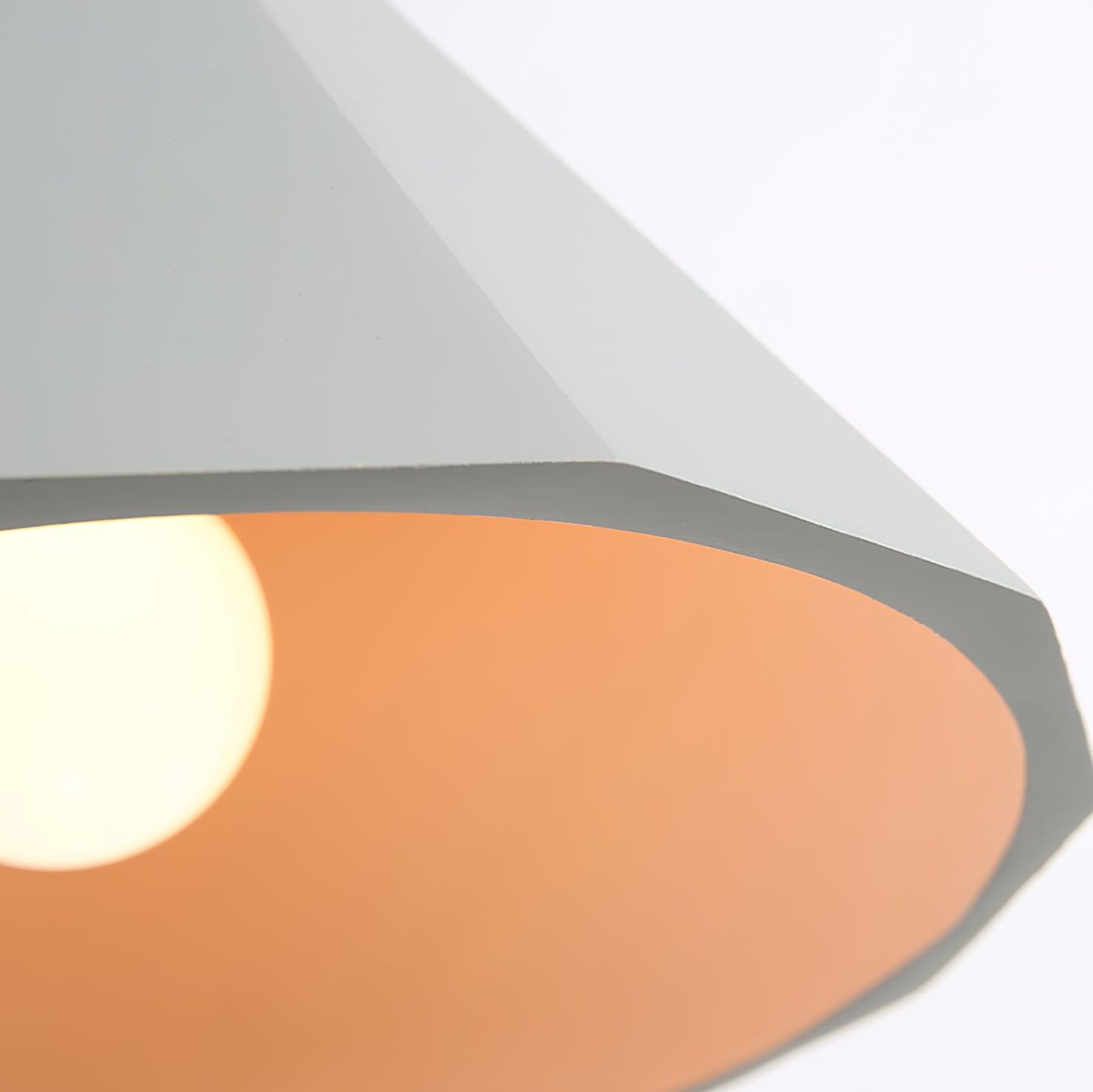 Pendant underside showing gold-coloured lining and illuminated bulb
