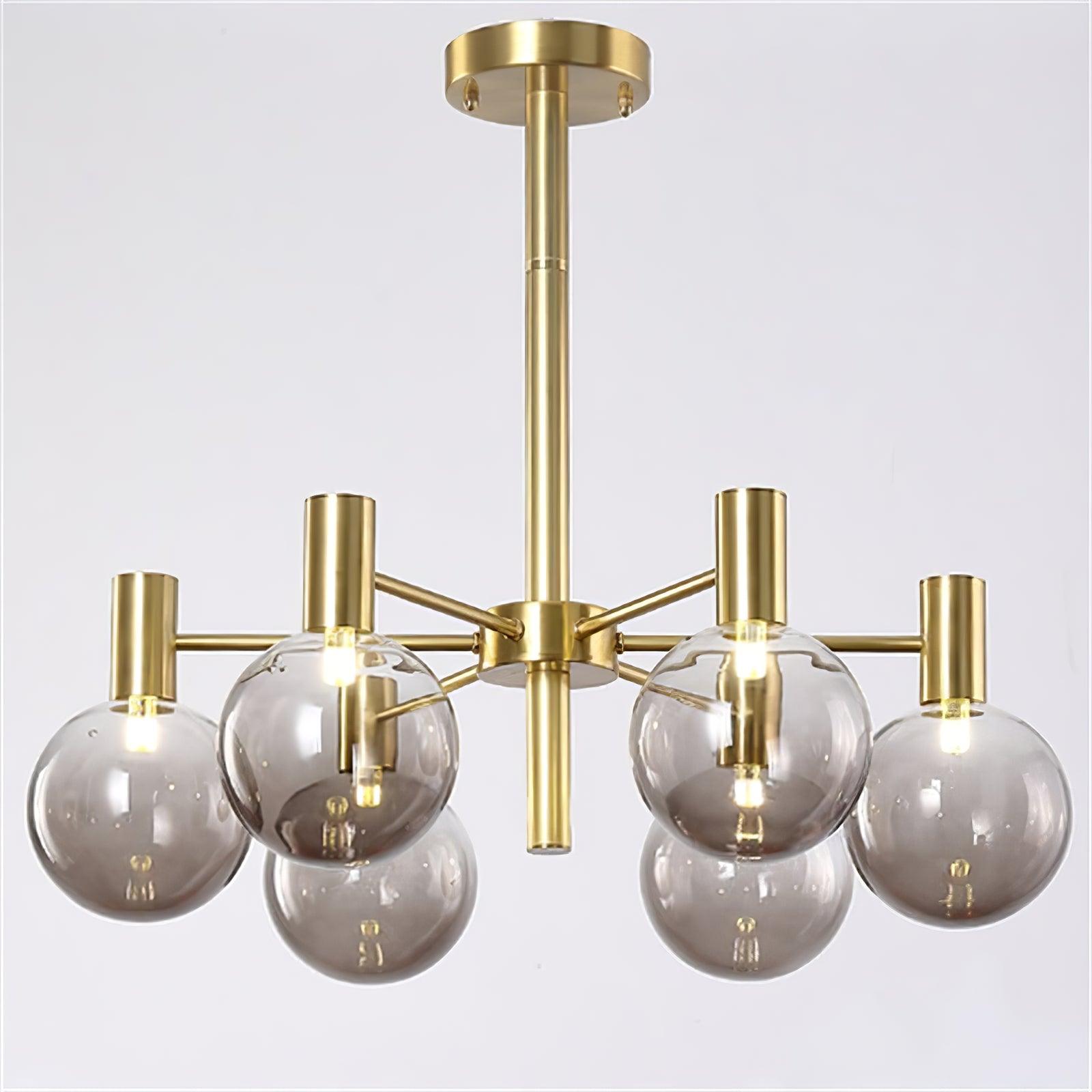 Front close view of a six-clear-globe chandelier with lit lamps, gold-tone arms, a ceiling rod and round canopy.