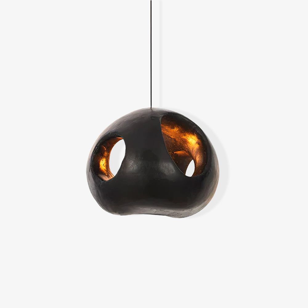 Black cutout pendant from the opposite front angle on white, with a larger opening at the right and warm-tone inner surfaces