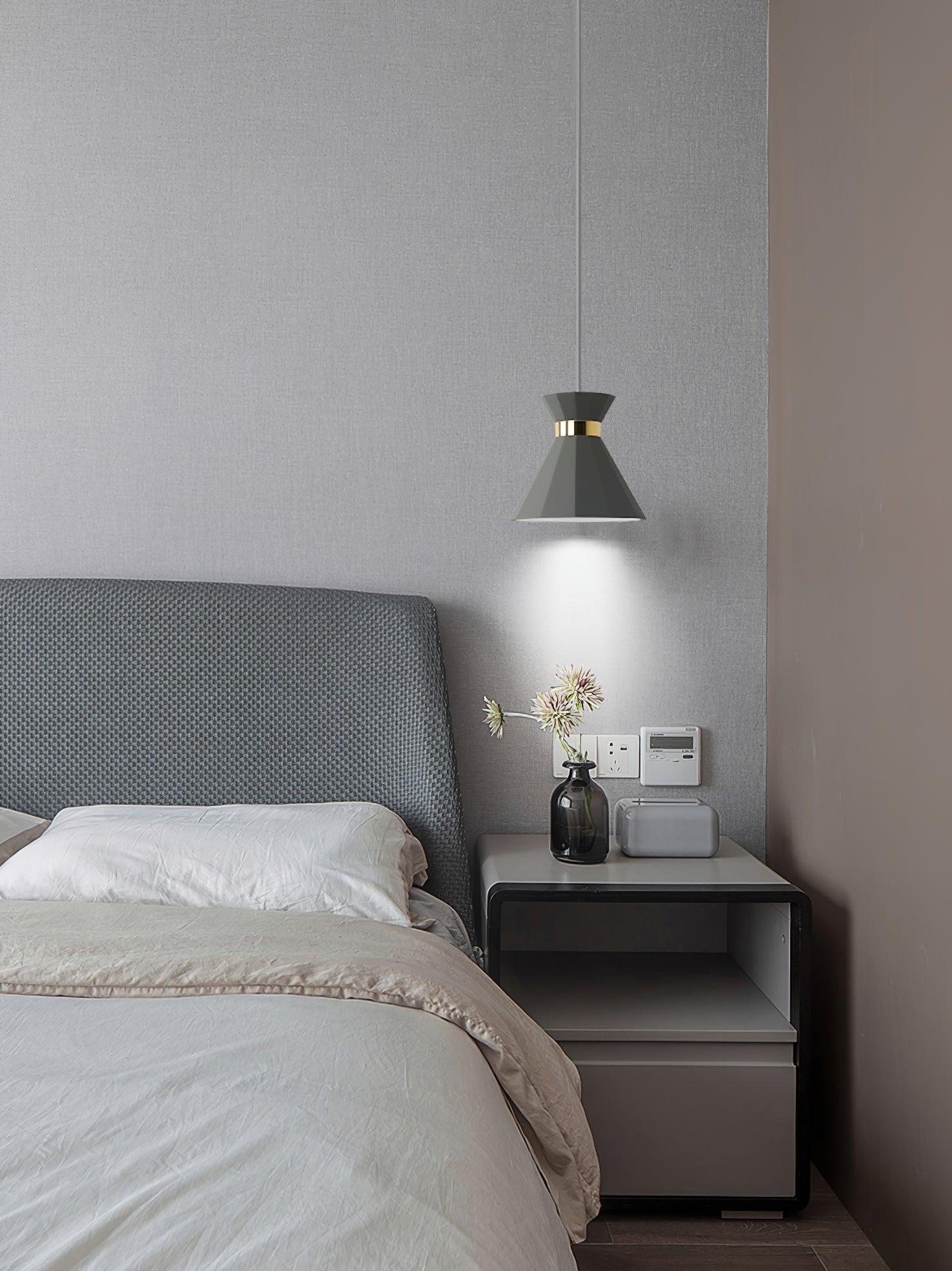 Grey bedside pendant casting light downward