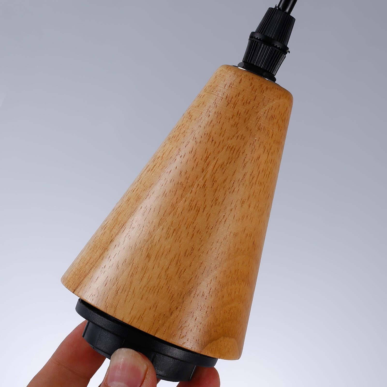 Wood-grain cap and black cord fitting on Besnier pendant