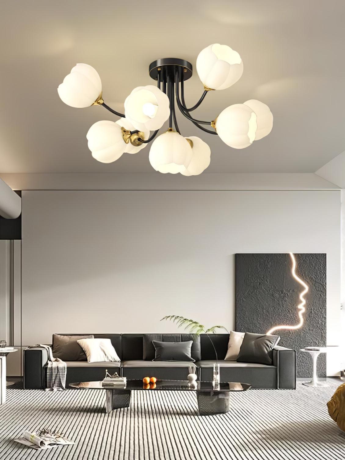 Black Pumpkin ceiling light with white glass shades above a black sofa and striped rug