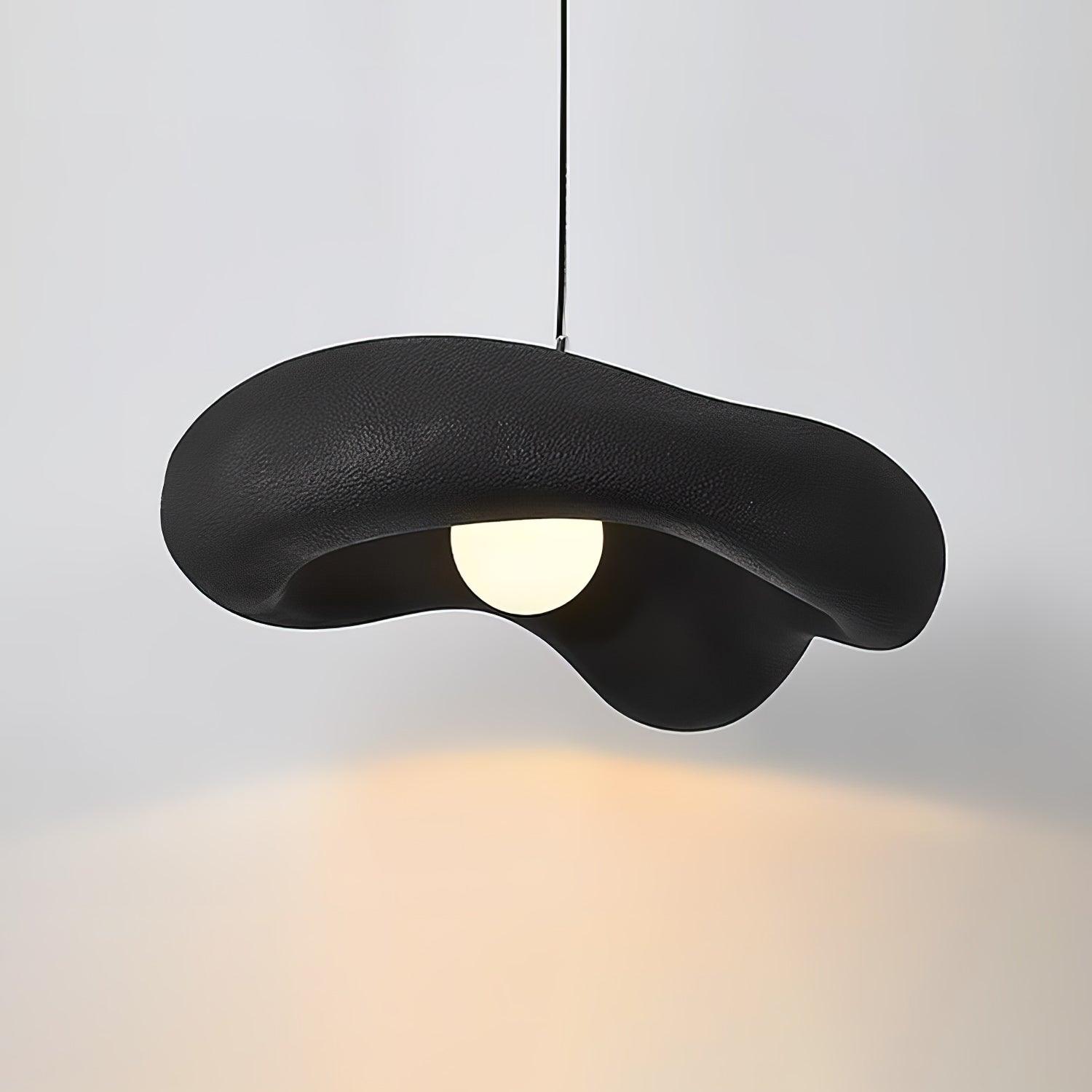 Black Lumina pendant with an undulating rim around a round glowing centre