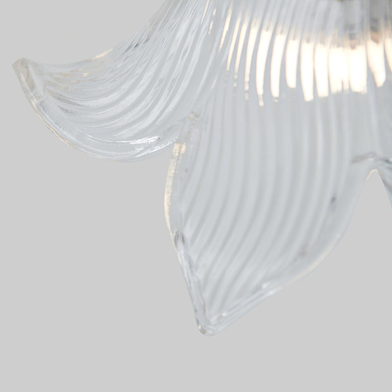 Macro of a clear ribbed glass petal edge curving upward, with bright light behind on pale grey.