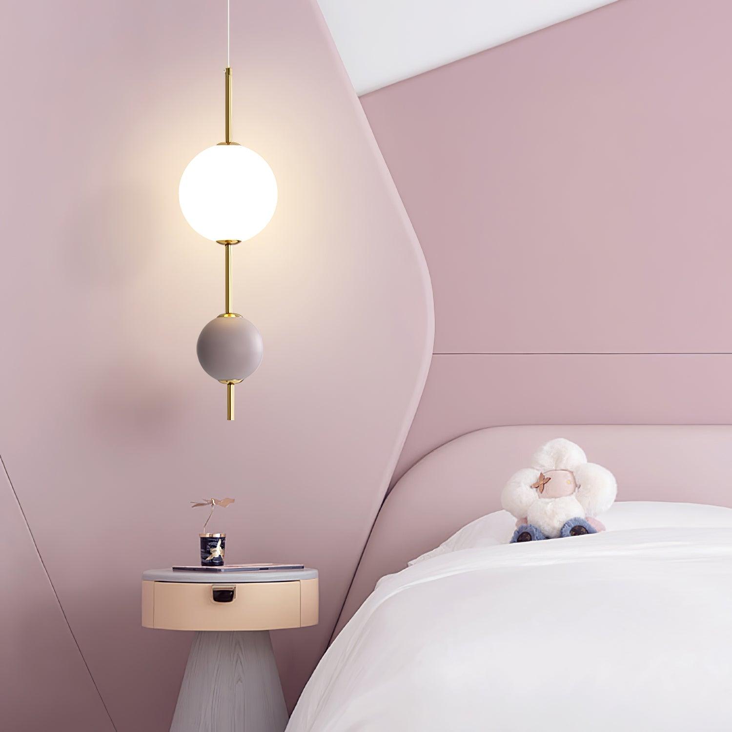 Violet two-ball pendant beside a bed