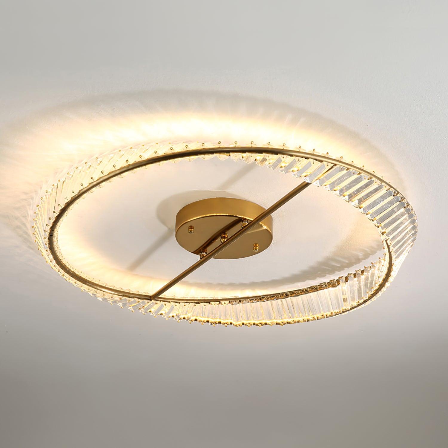 Illuminated gold-tone ring and clear glass pieces casting patterned light on the ceiling