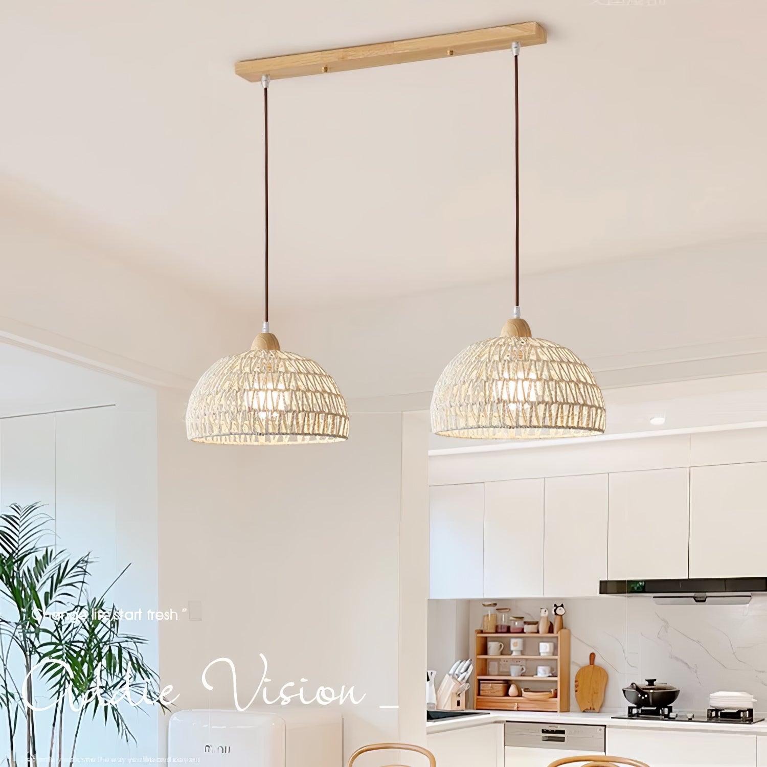 Two woven dome shades below a straight wood-tone ceiling bar in a white kitchen interior