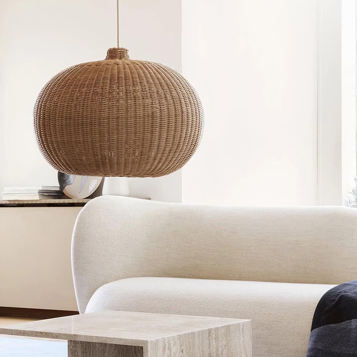 Rounded woven pendant above a pale living-room sofa