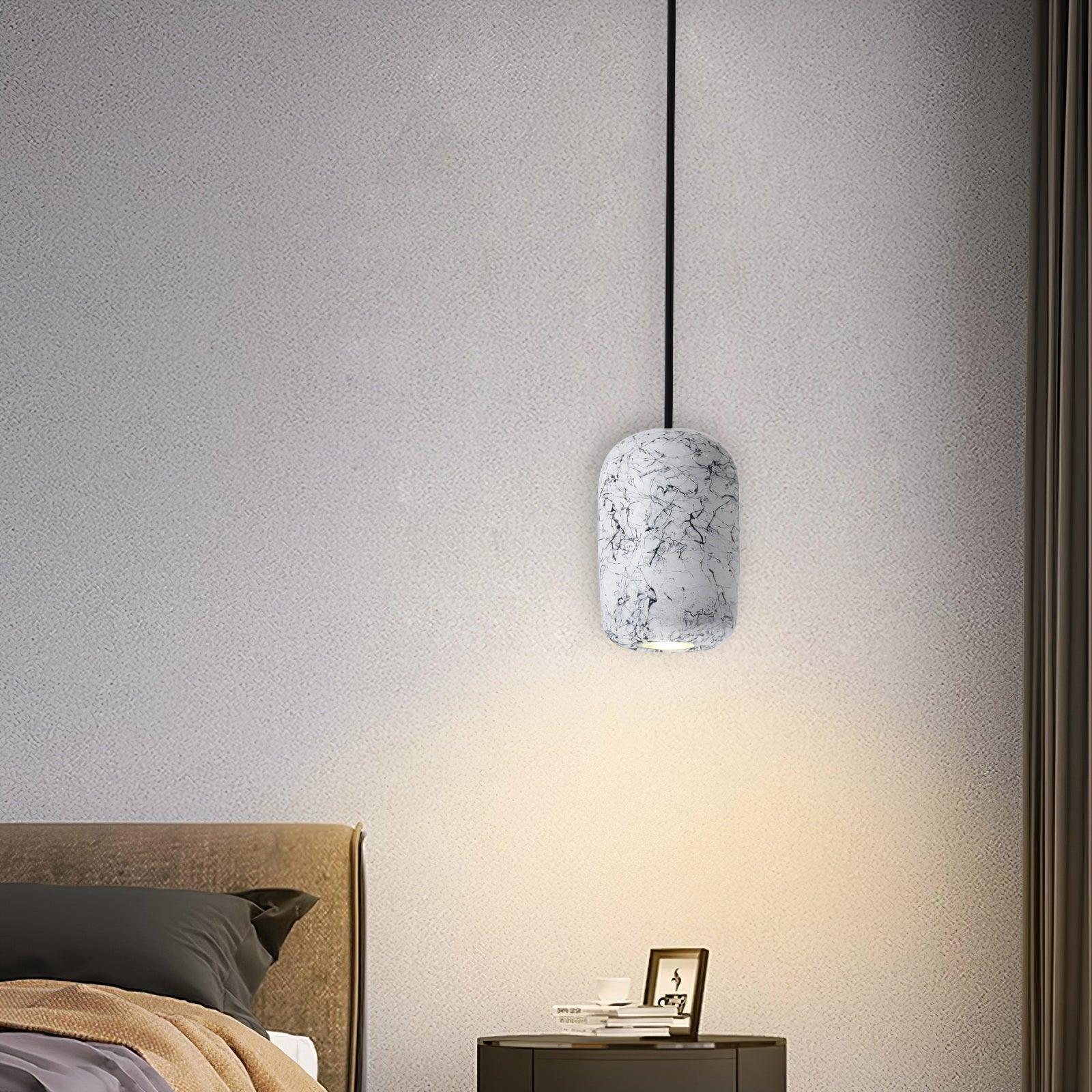 Rounded White cement cylinder beside a bed