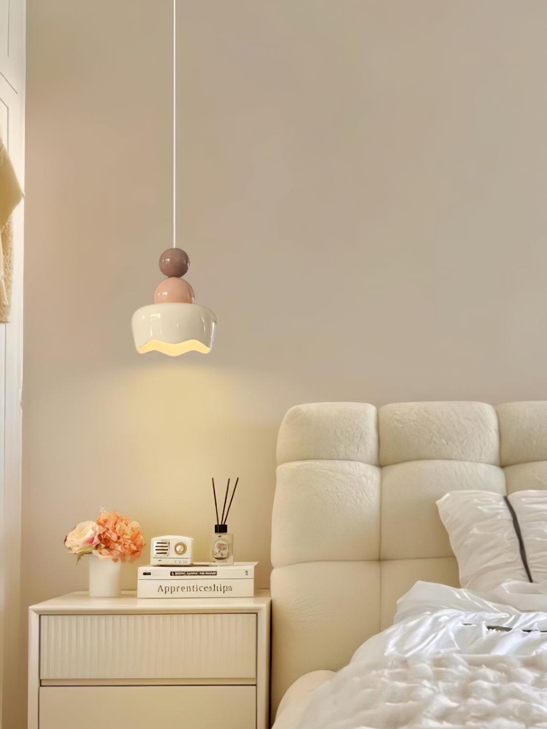 Doll pendant next to an upholstered headboard