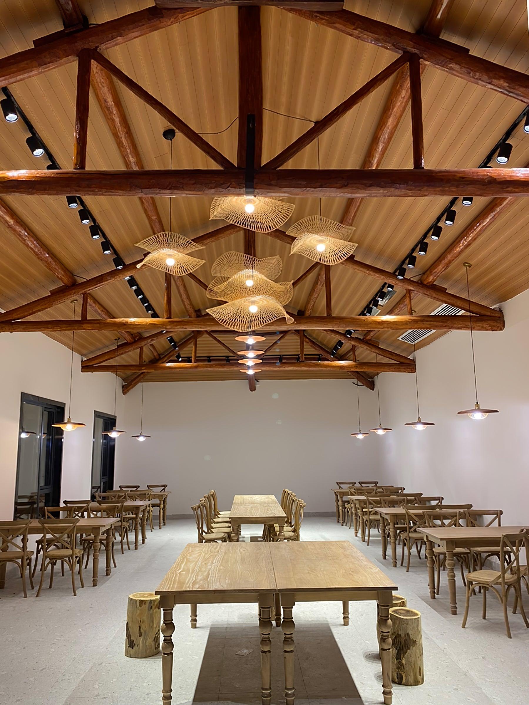 Open bamboo pendant frames beneath wooden beams